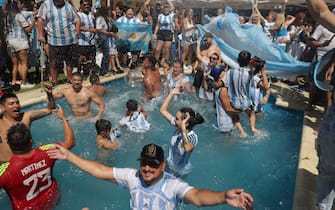 Fans of Argentina celebrate winning the Qatar 2022 World Cup at the former house of late football star Diego Maradona while watching the live broadcast of the final match against France in Buenos Aires, on December 18, 2022. (Photo by TOMAS CUESTA / AFP) (Photo by TOMAS CUESTA/AFP via Getty Images)