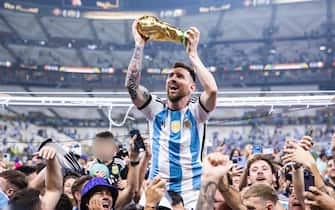 18 December 2022, Qatar, Lusail: Soccer: World Cup, Argentina - France, final round, final, Lusail Stadium, Argentina's Lionel Messi celebrates with the World Cup trophy. Photo: Tom Weller/dpa