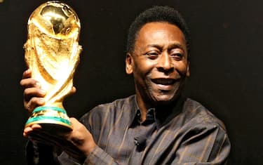 Brazilian football star Pele displays the FIFA World Cup during its presentation in Rio de Janeiro, Brazil on February 6, 2010. The cup is being exhibited in numerous countries while on a tour before reaching South Africa for the FIFA World Cup tournament that will be held next June. AFP PHOTO/GABRIEL LOPES (Photo credit should read GABRIEL LOPES/AFP via Getty Images)