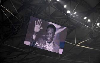A photograph of Brazilian football legend Pele is displayed on a giant screen prior to the French L1 football match between Olympique de Marseille and Toulouse FC at the Velodrome stadium in Marseille on December 29, 2022. - Football legend Pele died on December 29, 2022 at the age of 82. (Photo by Nicolas TUCAT / AFP)