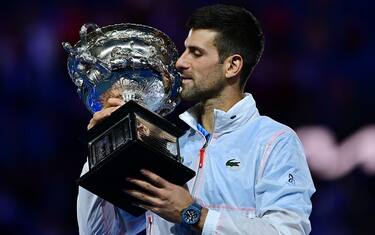 Serbia's Novak Djokovic celebrates with the Norman Brookes Challenge Cup trophy following his victory against Greece's Stefanos Tsitsipas in the men's singles final match on day fourteen of the Australian Open tennis tournament in Melbourne on January 29, 2023. - -- IMAGE RESTRICTED TO EDITORIAL USE - STRICTLY NO COMMERCIAL USE -- (Photo by MANAN VATSYAYANA / AFP) / -- IMAGE RESTRICTED TO EDITORIAL USE - STRICTLY NO COMMERCIAL USE -- (Photo by MANAN VATSYAYANA/AFP via Getty Images)