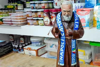 Una statuina di San Pio, con la stola del Napoli gia' campione, esposta in un negozio in citta', Napoli, 15  febbraio 2023.
ANSA / CIRO FUSCO