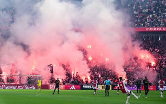 AMSTERDAM - Ajax supporters set off fireworks during the Dutch Eredivisie match between Ajax and Feyenoord at the Johan Cruijff ArenA on September 24, 2023 in Amsterdam, Netherlands. ANP OLAF KRAAK (Photo by ANP via Getty Images)
