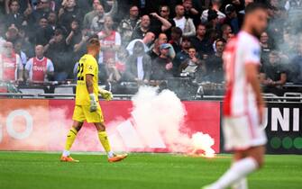 AMSTERDAM - Ajax supporters throw fireworks on the field during the Dutch Eredivisie match between Ajax and Feyenoord at the Johan Cruijff ArenA on September 24, 2023 in Amsterdam, Netherlands. ANP OLAF KRAAK (Photo by ANP via Getty Images)
