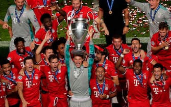 Bayern Munich's German goalkeeper Manuel Neuer (C) celebrates with teammates and the trophy after Bayern won the UEFA Champions League final football match between Paris Saint-Germain and Bayern Munich at the Luz stadium in Lisbon on August 23, 2020. (Photo by Manu Fernandez / POOL / AFP) (Photo by MANU FERNANDEZ/POOL/AFP via Getty Images)