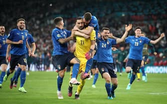 Italy players celebrate with goalkeeper Gianluigi Donnarumma after he saved the last penalty shoot-out following the UEFA Euro 2020 Final at Wembley Stadium, London. Picture date: Sunday July 11, 2021. (Photo by Nick Potts/PA Images via Getty Images)