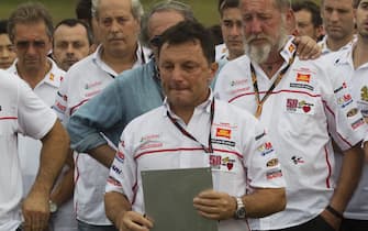 MALAYSIA MOTOGP epa03437134 MotoGP's San Carlo Honda Gresini team manager, Fausto Gresini (C) leads the installation of a plaque in memory of Italian rider Marco Simoncelli, who died in a crash in October 2011 during the Malaysian Grand Prix at Sepang International Circuit near Kuala Lumpur, Malaysia 18 October 2012. The 2012 MotoGP World Championship will take place at Sepang International Circuit in Malaysia from 19 until 21 October 2012. EPA/AHMAD YUSNI