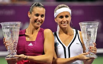 epa02423094 Doubles partners Flavia Pennetta (L) of Italy and Gisela Dulko of Argentina pose with their trophies after winning the doubles final on day six of the WTA Championships at the Khalifa Tennis Comple in Doha, Qatar on 31 October 2010.  EPA/STRINGER