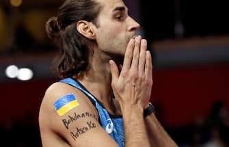 epa09837545 Gianmarco Tamberi of Italy, featuring the colors of the Ukranian flag, prepares to compete in the Men s High Jump final at the World Athletics Indoor Championships in Belgrade, Serbia, 20 March 2022.  EPA/ROBERT GHEMENT