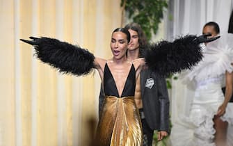 French model Ines Rau presents an outfit to be auctioned off on May 26, 2022 during the annual amfAR Cinema Against AIDS Cannes Gala at the Hotel du Cap-Eden-Roc in Cap d'Antibes, southern France, on the sidelines of the 75th Cannes Film Festival. (Photo by Stefano Rellandini / AFP) (Photo by STEFANO RELLANDINI/AFP via Getty Images)