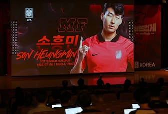 South Korea's footballer Son Heung-min is seen on a screen as journalists look on during a press conference to announce the South Korean squad for the Qatar 2022 FIFA World Cup football tournament, in Seoul on November 12, 2022. (Photo by Jung Yeon-je / AFP) (Photo by JUNG YEON-JE/AFP via Getty Images)