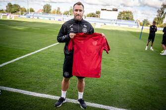 This picture taken on September 19, 2022 in Helsingborg, Denmark, shows Christian Eriksen, player of Denmark's national football team, wearing a black jersey and presenting the team's new red home jersey ahead of the upcoming FIFA 2022 Football World Cup. - Denmark will wear a "toned down" kit at this year's World Cup in protest at Qatar's human rights record, sportswear maker Hummel said on September 28, 2022, setting off a furious response from the Gulf state. Hummel said the new jerseys were "a protest against Qatar and its human rights record". "We don't wish to be visible during a tournament that has cost thousands of people their lives," the company said in an Instagram post that referred to reports of casualties among migrant labourers working on Qatar's mega infrastructure projects.
 - Denmark OUT (Photo by Mads Claus Rasmussen / Ritzau Scanpix / AFP) / Denmark OUT (Photo by MADS CLAUS RASMUSSEN/Ritzau Scanpix/AFP via Getty Images)