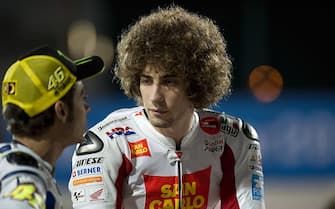 DOHA, QATAR - APRIL 09:  Valentino Rossi of Italy and Fiat Yamaha Team speaks with Marco Simoncelli of Italy and San Carlo Honda Gresini during the official photo session at Losail Circuit on April 9, 2010 in Doha, Qatar.  (Photo by Mirco Lazzari gp/Getty Images)