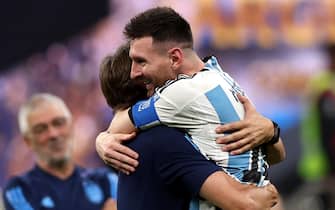 epa10372829 Lionel Messi (R) of Argentina celebrates with a teammember after winning the FIFA World Cup 2022 Final between Argentina and France at Lusail stadium, Lusail, Qatar, 18 December 2022.  EPA/Tolga Bozoglu