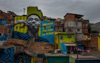 SAO PAULO, BRAZIL - JUNE 12: Children play soccer in front of the graffiti mural of the striker of the Brazilian soccer team Gabriel Jesus. The painting was done by a group of artists to pay homage to the attacker who grew up in the area, the Jardim Peri neighborhood that is one of the poorest neighborhoods in the city of São Paulo on June 12, 2018 in Sao Paulo, Brazil. (Photo by Victor Moriyama/Getty Images)