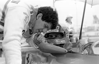Jody Scheckter leans over his Ferrari team mate Gilles Villeneuve to discuss the set-up during a practice session for the South African Grand Prix at Kyalami, 3rd March 1979. Villeneuve won and Scheckter came home second. (Photo by Klemantaski Collection/Getty Images)