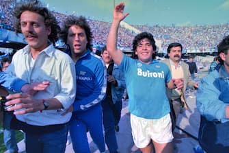 NAPLES, ITALY - MAY 10: Diego Maradona of Napoli celebrates the season champion after the Serie A match between Napoli and Fiorentina at the Stadio San Paolo on May 10, 1987 in Naples, Italy. (Photo by Etsuo Hara/Getty Images)