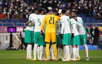 SAITAMA, JAPAN - FEBRUARY 01: Saudi Arabia players huddle prior to the FIFA World Cup Asian Qualifier Final Round Group B match between Japan and Saudi Arabia at Saitama Stadium on February 1, 2022 in Saitama, Japan. (Photo by Etsuo Hara/Getty Images)