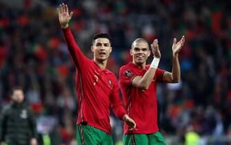 Portugal's forward Cristiano Ronaldo (L) and Pepe celebrate the victory at the end of the 2022 FIFA World Cup Qualifier football match between Portugal and North Macedonia at the Dragao stadium in Porto, Portugal, on March 29, 2022. (Photo by Pedro FiÃºza/NurPhoto via Getty Images)