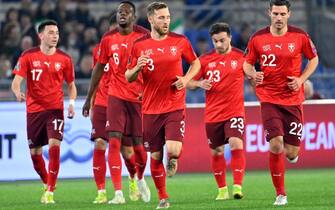 Switzerland's defender Silvan Widmer (C) celebrates after opening the scoring during the FIFA World Cup Qatar 2022 qualification Group C football match between Italy and Switzerland on November 12, 2021 at the Olympic stadium in Rome. (Photo by Alberto PIZZOLI / AFP) (Photo by ALBERTO PIZZOLI/AFP via Getty Images)