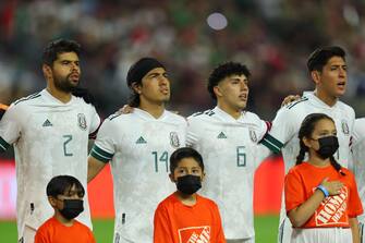 GLENDALE, AZ - JUNE 02: Mexico players (L-R) Nestor Araujo #2, Erick GutiÃ©rrez #14, Jorge SÃ¡nchez #6 and Edson Ã lvarez #4 of Mexico stand for their national anthem before to the friendly match between Uruguay and Mexico at State Farm Stadium on June 2, 2022 in Glendale, Arizona. (Photo by Omar Vega/Getty Images)