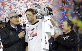 New England Patriots Tom Brady holds up the The Lamar Hunt Trophy after the game against the Indianapolis Colts in the AFC Championship Game at Gillette Stadium in Foxborough, Massachusetts on January 18, 2015. The winner of the game will represent the AFC at Super Bowl XLIX in Glendale, Arizona on February 1, 2015.    Photo by John Angelillo/ UPI