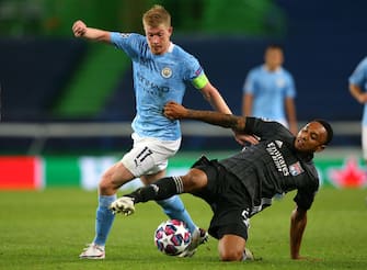 LISBON, PORTUGAL - AUGUST 15:  Kevin De Bruyne of Manchester City is tackled by Kenny Tete of Lyon during the UEFA Champions League Quarter Final match between Manchester City and Lyon at Estadio Jose Alvalade on August 15, 2020 in Lisbon, Portugal. (Photo by Alex Livesey - Danehouse/Getty Images)