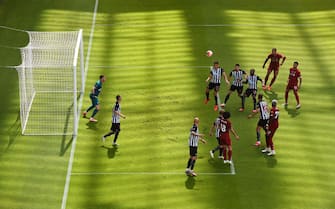 NEWCASTLE UPON TYNE, ENGLAND - JULY 26: Dwight Gayle of Newcastle United clears the ball from a corner the Premier League match between Newcastle United and Liverpool FC at St. James Park on July 26, 2020 in Newcastle upon Tyne, England. Football Stadiums around Europe remain empty due to the Coronavirus Pandemic as Government social distancing laws prohibit fans inside venues resulting in games being played behind closed doors. (Photo by Laurence Griffiths/Getty Images)
