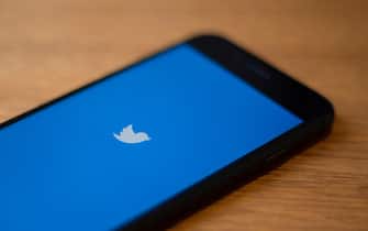 The Twitter logo is seen on a phone in this photo illustration in Washington, DC, on July 10, 2019. - Twitter is moving to filter out inappropriate content based on religion as part of its effort to curb hate speech. In a policy update on July 9, 2019, Twitter said it would take down "dehumanizing language" that targets specific religious groups.Examples shown by Twitter that would be removed would be description of a members of a religion as "disgusting" or "filthy animals." (Photo by Alastair Pike / AFP)        (Photo credit should read ALASTAIR PIKE/AFP via Getty Images)
