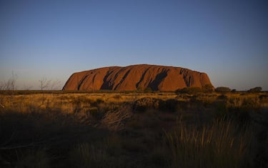 epa07950719 Uluru, also known as Ayers Rock is seen during sunset at Uluru-Kata Tjuta National Park in the Northern Territory, Australia, 26 October 2019. On 26 October 2019, an Uluru climbing ban came into effect. The ban was initially announced on 01 November 2017 and was made by the traditional owners of the land.  EPA/LUKAS COCH AUSTRALIA AND NEW ZEALAND OUT