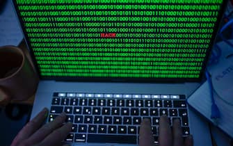04 January 2019, Mecklenburg-Western Pomerania, Schwerin: ILLUSTRATION - Between the binary code on a laptop monitor the English word "hack" can be seen.  (posed photo) Photo: Jens Büttner / dpa-Zentralbild / ZB