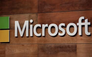 (FILES) In this file photo the Microsoft logo is pictured during the annual Microsoft shareholders meeting in Bellevue, Washington on November 29, 2017. - Microsoft will acquire artificial intelligence and cloud computing company Nuance for $19.7 billion, the company announced on April 12, 2021. Nuance's technology is used extensively in medical records, and the transaction will bolster Microsoft's healthcare offerings, Microsoft said in a news release. The transaction is all-cash and the sum includes Nuance's net debt. (Photo by Jason Redmond / AFP)