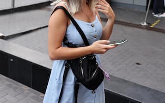 Una giovane tiene in mano uno smartphone