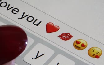 PARIS, FRANCE - FEBRUARY 14: In this photo illustration, emoji or emoticon representing a heart, lips, heart-shaped eyes and a kiss and the words "I love you" are displayed on the screen of an iPhone on Valentine's Day on February 14, 2020 in Paris, France. Valentine's Day is known as the Lovers' Day and the celebration of love and romance in many parts of the world. (Photo by Chesnot/Getty Images)