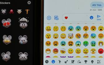 This photo illustration shows a selection of emojis and stickers displayed on smart phones in Washington, DC on December 19, 2019. - Researchers from the University of North Carolina at Chapel Hill and the Max Planck Institute for the Science of Human History have used a new tool in comparative linguistics to examine emotional concepts across the world, finding the way we think of things like anger, fear, and joy depends on our language. Their study drew on data from nearly 2,500 languages, including large ones with millions of speakers to small ones with thousands, and was published in the journal Science on December 19, 2019. (Photo by EVA HAMBACH / AFP) (Photo by EVA HAMBACH/AFP via Getty Images)