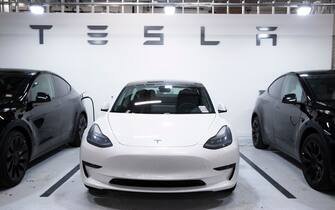 epa08997302 A Tesla Model 3 vehicle, at center, flanked by two Model Y vehicles that are used by a Tesla dealership as test-drive vehicles, are seen parked in a garage in Washington, DC, USA, 08 February 2021. Tesla purchased 1.5 billion US dollars worth of bitcoin, and announced it will soon start accepting the cryptocurrency as a form of payment for Tesla products.  EPA / MICHAEL REYNOLDS