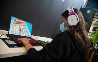 An attendee plays during a Epic Games - Fortnite tournament during the fourth day of the SOFA (Salon del Ocio y la Fantasia) 2021, a fair aimed to the geek audience in Colombia that mixes Cosplay, gaming, superhero and movie fans from across Colombia, in Bogota, Colombia on October 17, 2021.