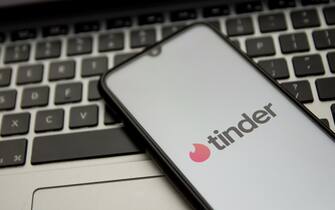 In this photo illustration a Tinder logo seen displayed on a smartphone screen with a computer keyword in the background in Athens, Greece on November 18, 2021. (Photo by Nikolas Kokovlis / NurPhoto via Getty Images)