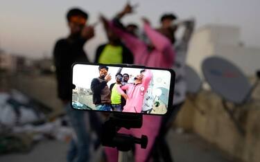 Youths act in front of a mobile phone camera while making a TikTok video on the terrace of their residence in Hyderabad on February 14, 2020. (Photo by NOAH SEELAM / AFP) (Photo by NOAH SEELAM/AFP via Getty Images)