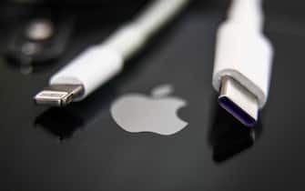 Lightning and USB-C cables are seen with Apple iPhone in this illustration photo taken in Krakow, Poland on September 25, 2021. (Photo by Jakub Porzycki/NurPhoto via Getty Images)