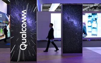 A visitor walks past the stand of American multinational corporation Qualcomm at the Mobile World Congress (MWC), the telecom industry's biggest annual gathering, in Barcelona on March 2, 2023. (Photo by Josep LAGO / AFP) (Photo by JOSEP LAGO/AFP via Getty Images)