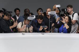 Attendees photograph Apple Vision Pro mixed reality (XR) headsets during the Apple Worldwide Developers Conference at Apple Park campus in Cupertino, California, US, on Monday, June 5, 2023. Apple Inc. will charge $3,499 for its long-awaited mixed-reality headset, testing whether consumers are ready to spend big bucks on a technology that the company sees as the future of computing. Photographer: Philip Pacheco/Bloomberg via Getty Images
