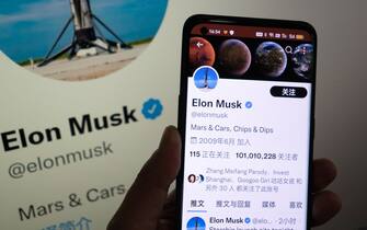 SHANGHAI, CHINA - JULY 13, 2022 - Photo taken on July 13, 2022 shows a Netizen in Shanghai, China, following Elon Musk's twitter page through his mobile phone and smart TV. Both Musk and Twitter have hired teams of lawyers to try to defend their interests and opinions. Twitter is suing Musk for $44 billion to complete the acquisition, and Musk is questioning the veracity of fake account data in Twitter's financial reports. (Photo credit should read CFOTO/Future Publishing via Getty Images)