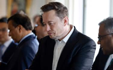 SpaceX, Twitter and electric car maker Tesla CEO Elon Musk (center) looks at other executives in front of a roundtable during the 6th Choose France Summit at the Château de Versailles near Paris, France, May 15, 2023.  ANSA /LUDOVIC MARIN / MAXPPP OUT POOL