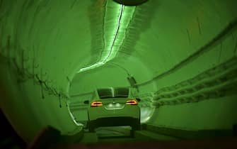 TOPSHOT - A modified Tesla Model X drives into the tunnel entrance before an unveiling event for the Boring Co. Hawthorne test tunnel in Hawthorne, south of Los Angeles on December 18, 2018. - On Tuesday night December 18, 2018, Boring Co. will officially open the Hawthorne tunnel, a preview of Elon Musk's larger vision to ease L.A. traffic. (Photo by Robyn Beck / POOL / AFP)        (Photo credit should read ROBYN BECK/AFP via Getty Images)