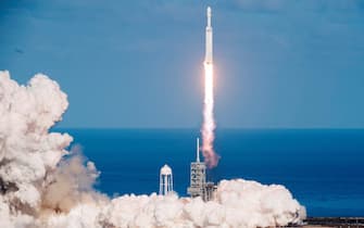 The SpaceX Falcon Heavy takes off from Pad 39A at the Kennedy Space Center in Florida, on February 6, 2018, on its demonstration mission. - The world's most powerful rocket, SpaceX's Falcon Heavy, blasted off Tuesday on its highly anticipated maiden test flight, carrying CEO Elon Musk's cherry red Tesla roadster to an orbit near Mars. Screams and cheers erupted at Cape Canaveral, Florida as the massive rocket fired its 27 engines and rumbled into the blue sky over the same NASA launchpad that served as a base for the US missions to Moon four decades ago. (Photo by JIM WATSON / AFP)        (Photo credit should read JIM WATSON/AFP via Getty Images)